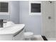 Updated bathroom featuring a modern vanity, commode, and tile shower at 9310 N 12Th St, Tampa, FL 33612