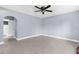 Spacious bedroom with arched doorway, ceiling fan, and neutral tile flooring throughout at 9310 N 12Th St, Tampa, FL 33612
