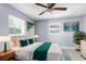 This bedroom boasts lots of natural light, ceiling fan, and coordinating decor at 9310 N 12Th St, Tampa, FL 33612