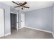 Empty bedroom featuring a ceiling fan, tiled flooring, and doorways leading to other rooms at 9310 N 12Th St, Tampa, FL 33612