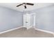 Empty bedroom with light blue walls, closet, and tile flooring at 9310 N 12Th St, Tampa, FL 33612