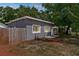 View of the home's exterior showcasing partial backyard with wood fence at 9310 N 12Th St, Tampa, FL 33612