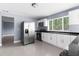Bright kitchen featuring stainless steel appliances, white cabinets, and dark countertops at 9310 N 12Th St, Tampa, FL 33612
