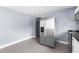 Open kitchen area featuring a stainless steel refrigerator, tiled flooring and arched doorways at 9310 N 12Th St, Tampa, FL 33612