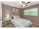 Comfortable bedroom featuring a ceiling fan, a charming painting, and a light-colored wooden bed frame at 940 Virginia St # 303, Dunedin, FL 34698