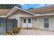 A well maintained community clubhouse with brick pavers leading to a set of double doors at 940 Virginia St # 303, Dunedin, FL 34698