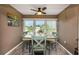 Cozy dining area featuring a wooden table, and 4 chairs, complimented by a large window at 940 Virginia St # 303, Dunedin, FL 34698