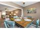 Open dining area with views of the living room and coastal themed art at 940 Virginia St # 303, Dunedin, FL 34698