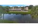 Condo complex overlooking the water with palm trees and covered parking at 940 Virginia St # 303, Dunedin, FL 34698