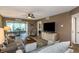 Comfortable living room featuring wood flooring, ceiling fan, with views of the dining area and a hallway at 940 Virginia St # 303, Dunedin, FL 34698