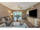 Inviting living room with modern decor, wood floors, a ceiling fan, and an open layout at 940 Virginia St # 303, Dunedin, FL 34698