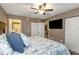 Comfortable main bedroom with a ceiling fan, large bed, and closet space at 940 Virginia St # 303, Dunedin, FL 34698