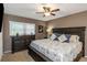 Comfortable main bedroom features a ceiling fan, dresser, and large bed with pillows at 940 Virginia St # 303, Dunedin, FL 34698