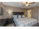 Comfortable main bedroom features a ceiling fan, dresser, and large bed with pillows at 940 Virginia St # 303, Dunedin, FL 34698