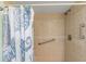Tiled shower with shower curtain and handicap bar at 940 Virginia St # 303, Dunedin, FL 34698