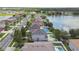 Scenic aerial view of homes, a tranquil lake, and lush trees, offering a picturesque neighborhood setting at 31111 Bridgegate Dr, Wesley Chapel, FL 33545