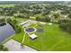 Aerial view of a park with multiple recreational areas, featuring play structures, sports courts and green spaces at 31111 Bridgegate Dr, Wesley Chapel, FL 33545