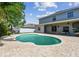 Spacious backyard with a freeform pool, covered patio and ample room for entertaining at 31111 Bridgegate Dr, Wesley Chapel, FL 33545
