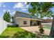 Well-maintained backyard with a covered patio, lush lawn, and lovely pool surrounded by green grass at 31111 Bridgegate Dr, Wesley Chapel, FL 33545