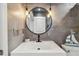 Chic bathroom featuring a modern vanity with a round mirror and stylish lighting at 31111 Bridgegate Dr, Wesley Chapel, FL 33545