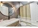 Stylish bathroom features a modern sink, vanity, round mirror, and a bathtub with nautical accents at 31111 Bridgegate Dr, Wesley Chapel, FL 33545