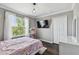 Charming bedroom featuring a window, wood floors, and modern decor at 31111 Bridgegate Dr, Wesley Chapel, FL 33545