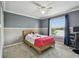 Bright bedroom featuring a ceiling fan, large window, and a comfortable bed at 31111 Bridgegate Dr, Wesley Chapel, FL 33545