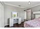 Stylish bedroom featuring a large vanity, wood floors, and neutral decor at 31111 Bridgegate Dr, Wesley Chapel, FL 33545