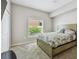 Bright bedroom with a queen bed, a closet, and a window bringing in natural light at 31111 Bridgegate Dr, Wesley Chapel, FL 33545