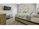 Bright bedroom with a queen bed, closet, and window offering a pleasant view at 31111 Bridgegate Dr, Wesley Chapel, FL 33545