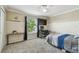Well-lit bedroom featuring a large window, carpet flooring, and neutral decor at 31111 Bridgegate Dr, Wesley Chapel, FL 33545