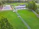 Aerial view of community park featuring pickleball court, playground, picnic shelter and green space at 31111 Bridgegate Dr, Wesley Chapel, FL 33545