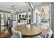 Open concept dining area with modern light fixture, wood table, and access to a covered outdoor patio at 31111 Bridgegate Dr, Wesley Chapel, FL 33545