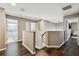 Upstairs hallway with hardwood floors leading to bedrooms and a bathroom, offering easy access to the home's amenities at 31111 Bridgegate Dr, Wesley Chapel, FL 33545