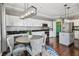 Kitchen showcasing white cabinetry, granite countertops, stainless appliances, and decorative lighting at 31111 Bridgegate Dr, Wesley Chapel, FL 33545