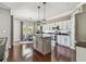 Bright kitchen with stainless steel appliances, granite countertops, pendant lighting, and hardwood floors, offering style and functionality at 31111 Bridgegate Dr, Wesley Chapel, FL 33545
