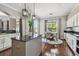 Bright kitchen with island, hardwood floors, and breakfast nook with backyard view at 31111 Bridgegate Dr, Wesley Chapel, FL 33545