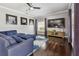 Spacious living room with hardwood floors, recessed lighting, large television, and comfortable blue sectional sofa at 31111 Bridgegate Dr, Wesley Chapel, FL 33545