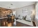 Open-concept living and dining area with hardwood floors, stylish lighting, and comfortable seating for entertaining at 31111 Bridgegate Dr, Wesley Chapel, FL 33545