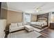Spacious main bedroom with a seating area, hardwood floors, and stylish decor at 31111 Bridgegate Dr, Wesley Chapel, FL 33545
