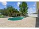 Private backyard oasis featuring a freeform pool, brick paver patio and lush green surroundings at 31111 Bridgegate Dr, Wesley Chapel, FL 33545