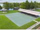 Overhead shot of a recreational court with picnic tables and shelters near a pond at 31111 Bridgegate Dr, Wesley Chapel, FL 33545