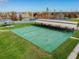 Overhead shot of a recreational court with picnic tables and shelters near a pond at 31111 Bridgegate Dr, Wesley Chapel, FL 33545