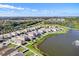 Aerial view of a housing community surrounded by trees and several ponds at 10024 Merry Fawn Ct, Sun City Center, FL 33573