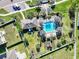 Aerial view of a community pool, playground, and meticulously landscaped common areas at 10024 Merry Fawn Ct, Sun City Center, FL 33573