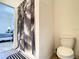 Bathroom featuring black-and-white shower curtain and toilet with tiled floor at 10024 Merry Fawn Ct, Sun City Center, FL 33573