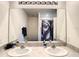 Bright bathroom with a double sink vanity and large mirror with overhead lighting at 10024 Merry Fawn Ct, Sun City Center, FL 33573