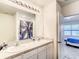 Bathroom featuring double sinks and shower with blue palm tree curtain at 10024 Merry Fawn Ct, Sun City Center, FL 33573