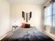 Bedroom featuring a plush gray bed, window with blinds, and modern artwork at 10024 Merry Fawn Ct, Sun City Center, FL 33573