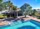Stunning community pool and cabana with clear blue water, landscaping, and lounge seating at 10024 Merry Fawn Ct, Sun City Center, FL 33573